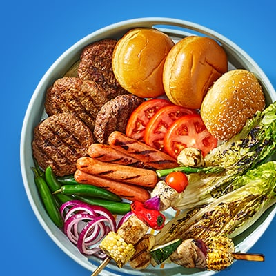 Fresh vegetable platter, grilled kebabs, and a platter of grilled burgers, buns, tomatoes and more for your cookout.