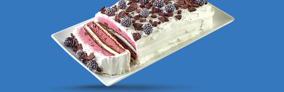 ice cream cake with white icing, blueberries and crushed chocolate cookies