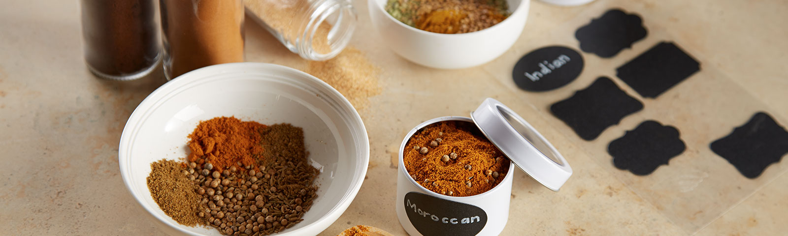 Different spices in white bowls on a table