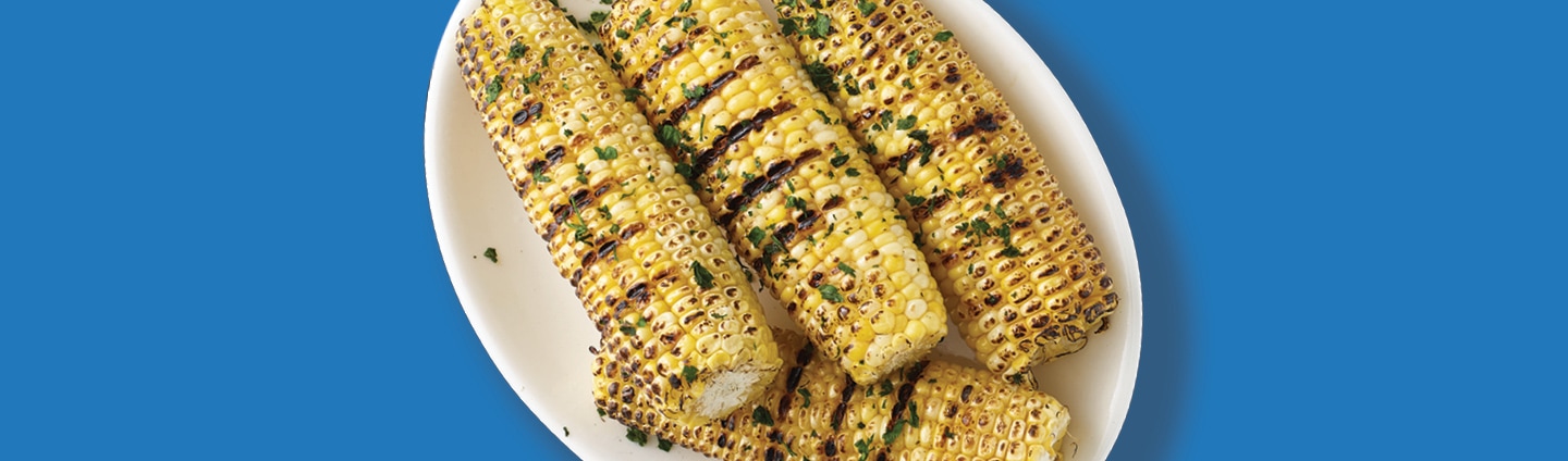 A plate of grilled corn on the cob