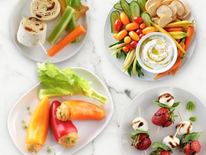 Four plates of colorful meals