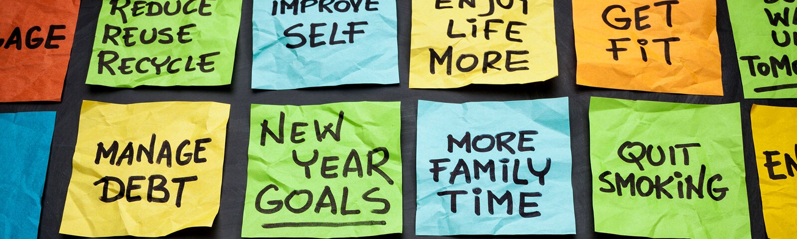 Different color posted notes with new year resolutions