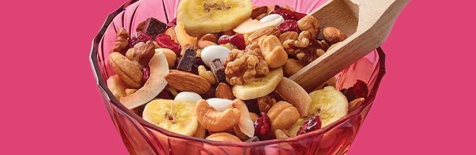 Trail mix with dried fruit, assorted nuts, toasted coconut flakes, chocolate and raisins.