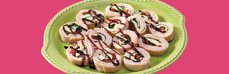 Caprese Turkey Roll-Ups with balsamic glaze drizzled on top