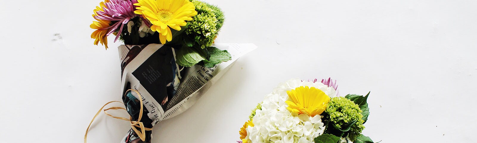 Newspaper wrapped bunches of flowers