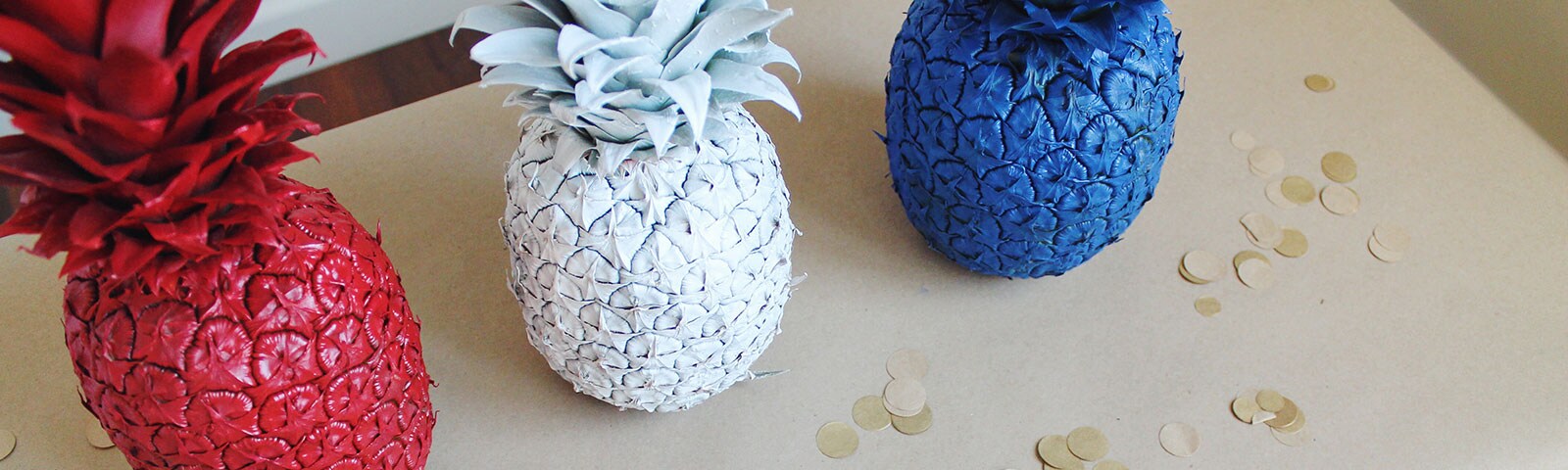 Red, White, and Blue colored pineapples on a table