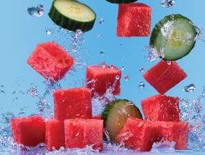fresh watermelon cubes and cucumber slices with splashes of water